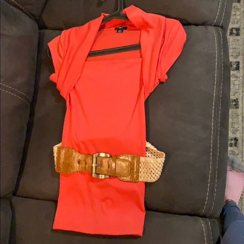Coral shirt with a belt.